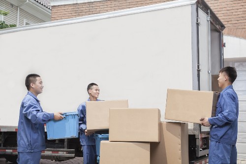 Professional packers handling moving boxes in Storage Wandsworth